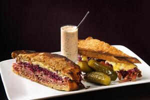 Pastrami sandwich with shredded red cabbage and cheese on toasted bread photo