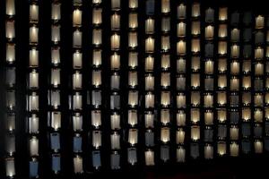 bar wall decorated with illuminated bottles photo