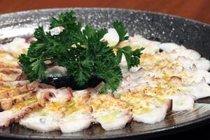 Octopus carpaccio with mustard and olive oil photo