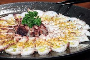 Octopus carpaccio with mustard and olive oil photo