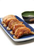 Guioza, Japanese dumpling with a filling of pork, ginger, cabbage, garlic and special sauce to accompany photo