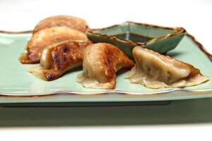 Guioza, Japanese dumpling with a filling of pork, ginger, cabbage, garlic and special sauce to accompany photo