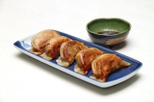 Guioza, Japanese dumpling with a filling of pork, ginger, cabbage, garlic and special sauce to accompany photo