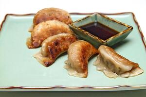 Guioza, Japanese dumpling with a filling of pork, ginger, cabbage, garlic and special sauce to accompany photo