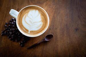 cup of coffee and coffee beans on dark background, top view photo