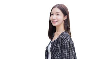 Portrait of a beautiful, long haired Asian female in black pattern coat with braces on teeth walking and smiling while isolated white background. photo