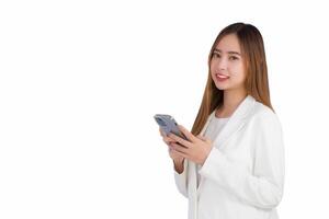 Portrait asian professional business female is wears white suite holding smartphone which is interesting as it can be used in various contexts where identity while isolated white background. photo