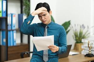Image of Asian male businessman working in the office photo