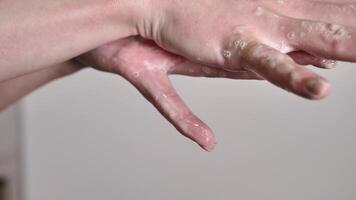 washing woman's hands with soap and water to remove dirt and germs close-up on white background. The fingers move gently and slowly video