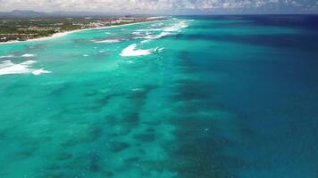 Aerial view capturing the vibrant colors of the Great Barrier Reef landscape, with its colorful coral formations contrasting against the turquoise ocean. The bright glow of the Atlantic Ocean video