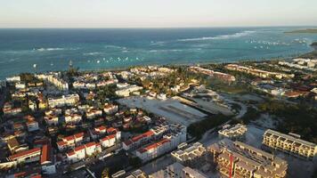 Aerial view of sizable building site situated in tourist hub with view of sea, complete with tower crane, located in Punta Cana, Dominican Republic. video