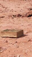 old book in red rock desert video
