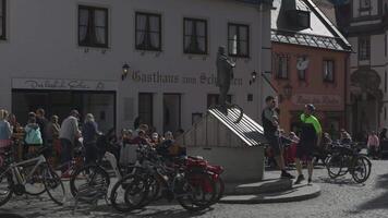March 31, 2024. Fussen, Germany. Altstadt, Fuessen, Bayern, Deutschland. Old town in sunny weather with people resting, cafes and restaurants. Historical old bavarian buildings at Fussen. video