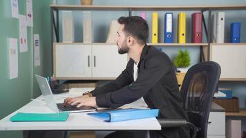 Young businessman working in his office. video