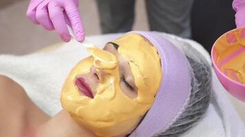ung kvinna får skönhet ansiktsbehandling injektioner i salong. ansikte åldrande, föryngring och hydratisering förfaranden. estetisk kosmetologi. video
