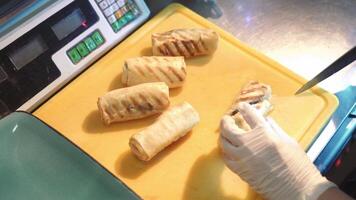 Chef cutting pancakes on a board. Pancakes filled with meat filling video