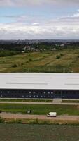 Modern distribution center from above. Aerial view of warehouse storage of industrial factory Vertical video