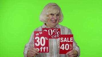 Grandma showing sale percent discounts advertisement inscriptions banners. Black Friday concept video