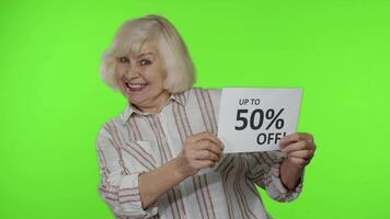 Senior grandmother showing Sale 50 percent Off banner advertisement. Online shopping. Black Friday video