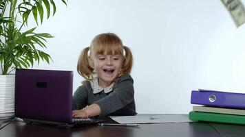 Young child girl boss in rain of falling money is rejoicing, celebrating the winning lottery game video