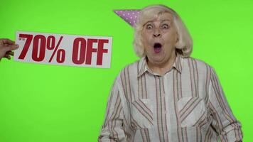 Advertisement Up To 70 Percent Off appears next to grandmother. Woman celebrating with shopping bags video