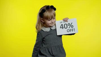 Pupil girl with shopping bags showing Up To 40 percent Off banner text advertisement. Holiday sale video