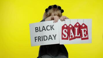 Child kid showing Black Friday and Sale word discount advertisement banners. Low prices, shopping video