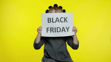 Child girl showing Black Friday inscription banner text advertisement. Low prices online shopping video