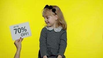 Inscription Up To 70 Percent Off appears next to smiling child girl. Preschooler kid celebrating video