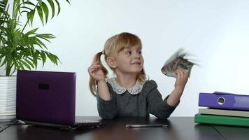 Child girl boss holding pile of dollar cash bills. Baby businesswoman kid holding money in hands video