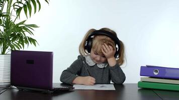 Preschool child girl distance online learning at home. Kid studying using digital laptop computer video