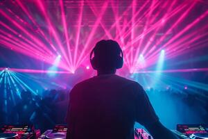 Male DJ on a big rave playing for a big crowd of party people, ravers dancing, big laser show photo