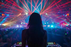 Female DJ on a big rave playing for a big crowd of party people, ravers dancing, big laser show photo