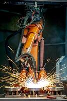 Industrial robot is welding metal. Robotic Welding laser cutting machine photo