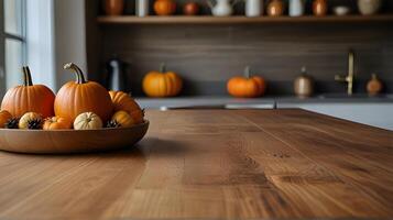 Wooden table and pumpkins, rustic kitchen interior with autumn fall decorations, blurred background.Selective focus and copy space. photo