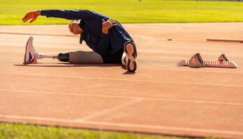 Asian para-athlete runner prosthetic leg on the track alone outside on a stadium track Paralympic running concept. photo