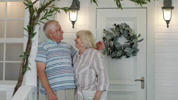 Senior couple husband and wife embracing, showing love each to other in porch at home. Mature family video