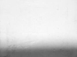 blanco grunge hormigón pared antecedentes con ligero haz en superficie y sombra a el abajo. foto