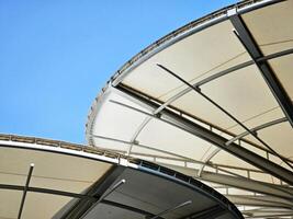 Exterior view of rounded roof with blue sky. photo