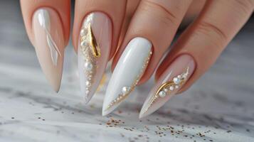 Elegant gold and pearl nail art design. . photo