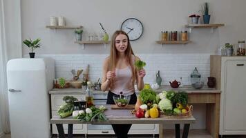 Girl throwing pieces of lettuce on plate, telling the recipe. Cooking salad with raw vegetables video