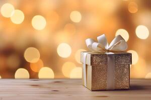 Golden gift box with a bow, on wooden surface with bokeh background with copy space photo