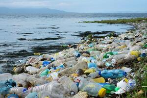 A beach littered with plastic trash, polluting the ocean and harming marine life. photo