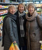 dos alemán mujer sonriente mientras compras en un supermercado, en pie lado por lado entre vistoso Tienda pantallas. foto