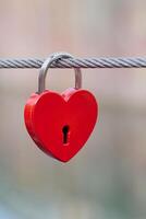 red metal love lock hanging at a bridge in Colmar, France photo