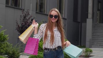 Student teen girl with shopping bags. Good Black Friday holiday sale discounts, low price purchases video