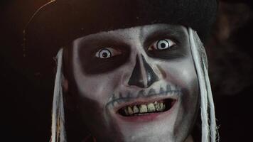 Man with skeleton creepy makeup trying to scare, opening his mouth and showing dirty black teeth video