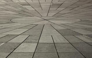 Texture of gray tsetse sidewalk in sunlight in Tallinn. Gray rectangular tiles in perspective. Background. Horizontal. photo