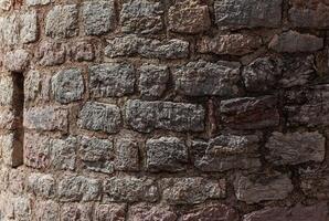 Stone texture of a wall in Montenegro. An ancient wall made of brown coloured stones. Background. Template. For design. Horizontal. photo