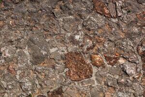 Stone texture of a wall in Montenegro. An ancient wall made of brown coloured stones. Background. Template. For design. Horizontal. photo